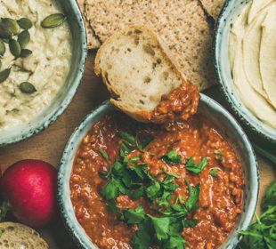 Spread of exotic dips with vegetables and bread