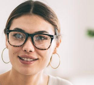 A woman wearing glasses in a meeting