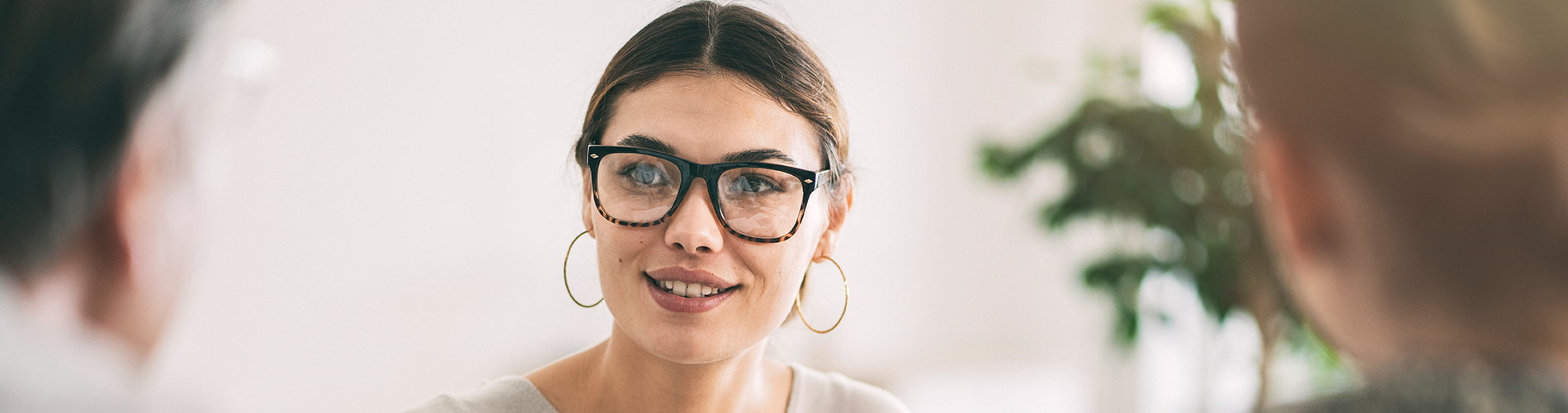 A woman wearing glasses in a meeting