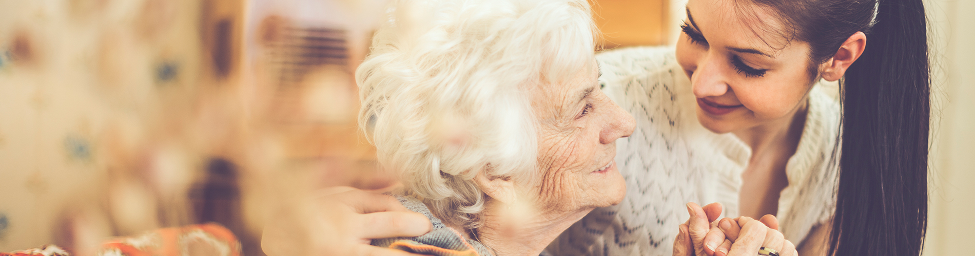 Young woman hugging a senior