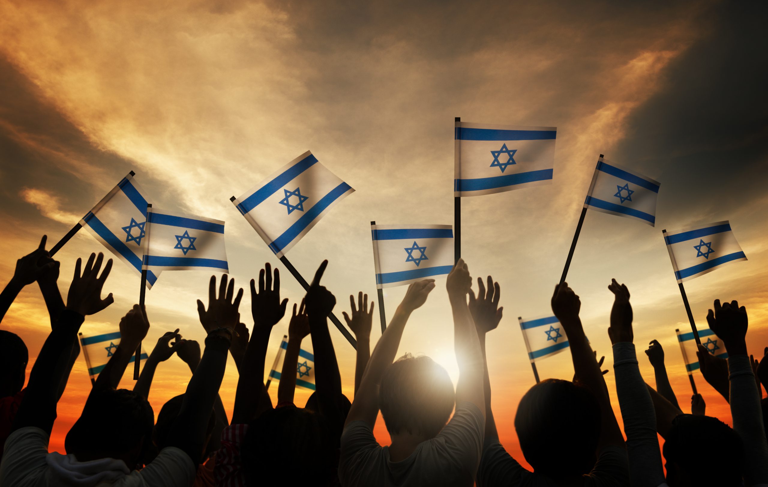 Group of People Waving the Flag of Israel