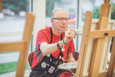 Older adult painting at Myerberg