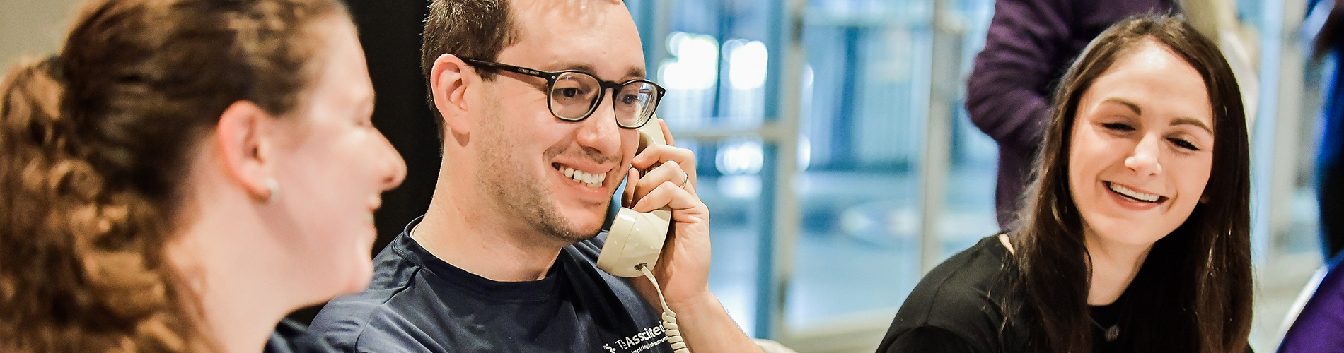 associated employees smiling while talking on telephone