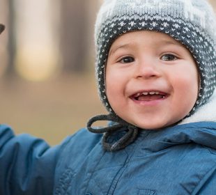 Toddler Playing Outdoors in Cold Weather