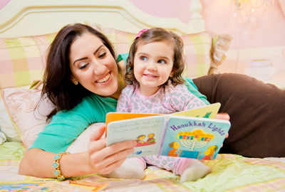 mother reading PJ Library book to daughter