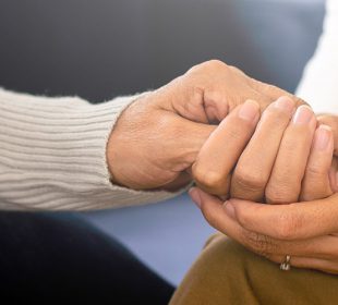 Women Offering Support by Holding Hands