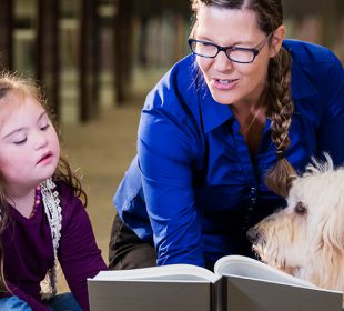 Children Practicing Reading with Support Dog