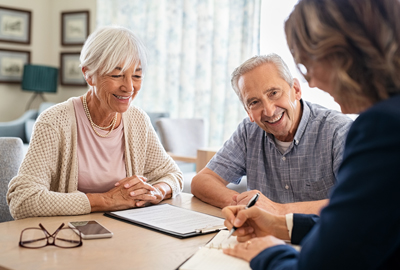 Senior couple consulting with financial agent 