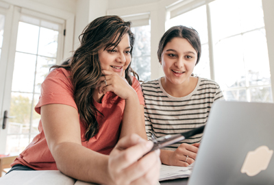 mother helps daughter with homework