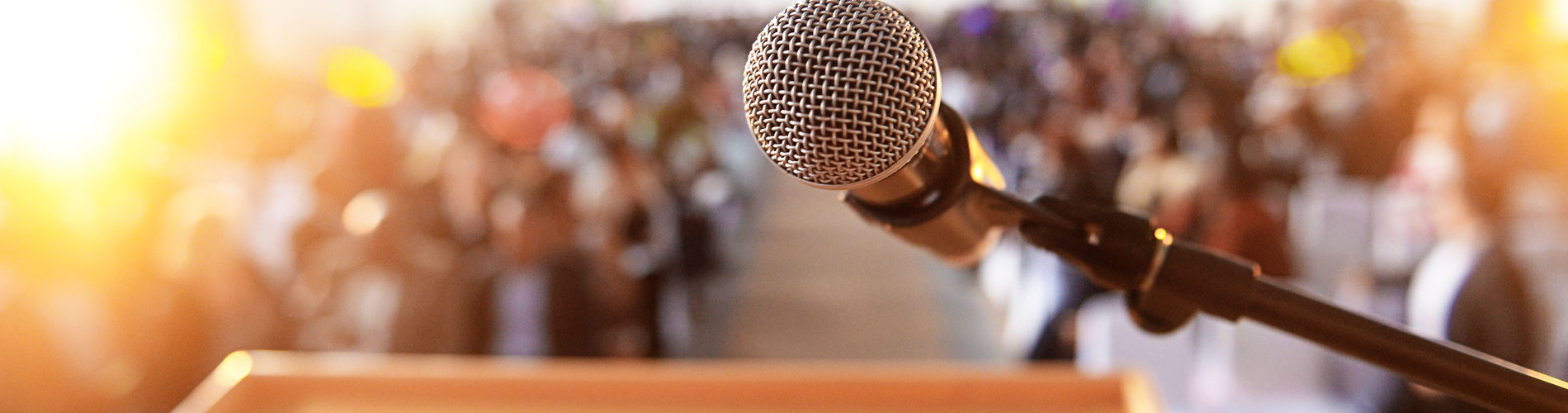 Microphone in front of podium with crowd