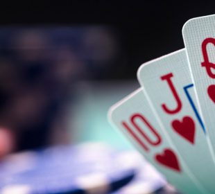 Playing poker, holding winning royal flush hand of cards
