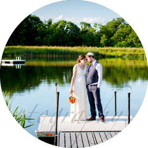 Bride and groom standing on dock
