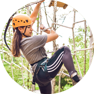 Woman attempting ropes course at Pearlstone