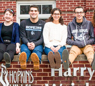 Students smiling in front of Hopkins Hillel