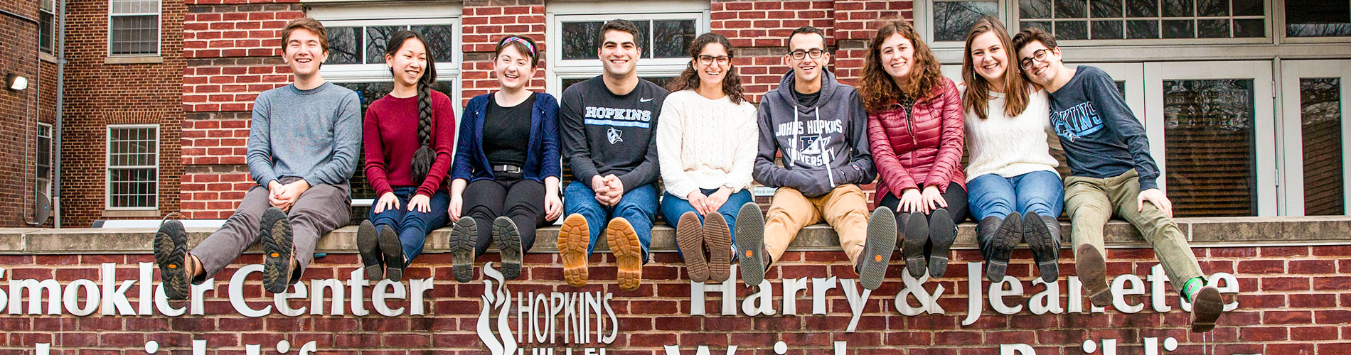 Students smiling in front of Hopkins Hillel