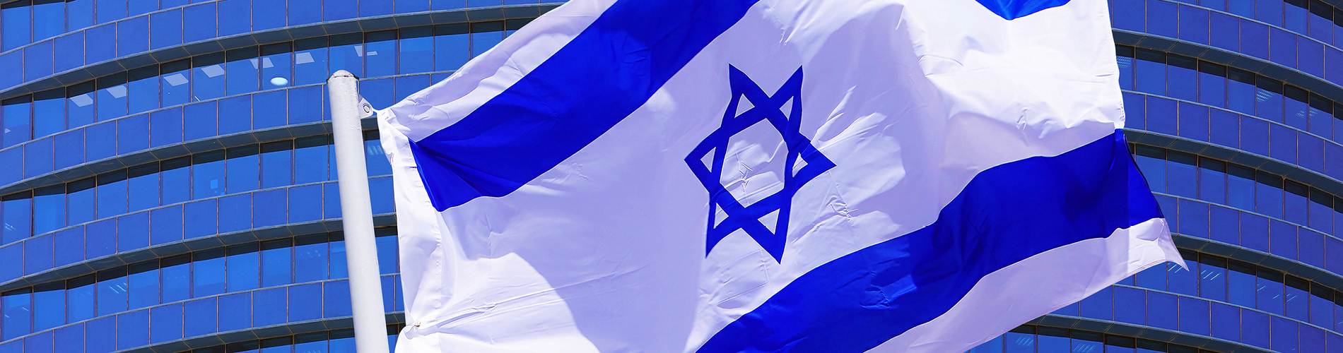Israel flag flying in front of building
