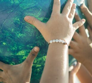 children holding up globe