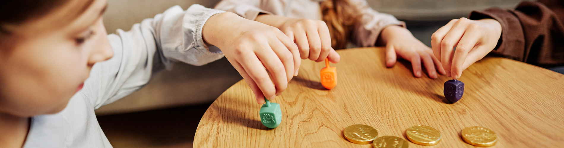 kids playing dreidel for chanukah