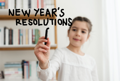 young girl writing new year's resolutions