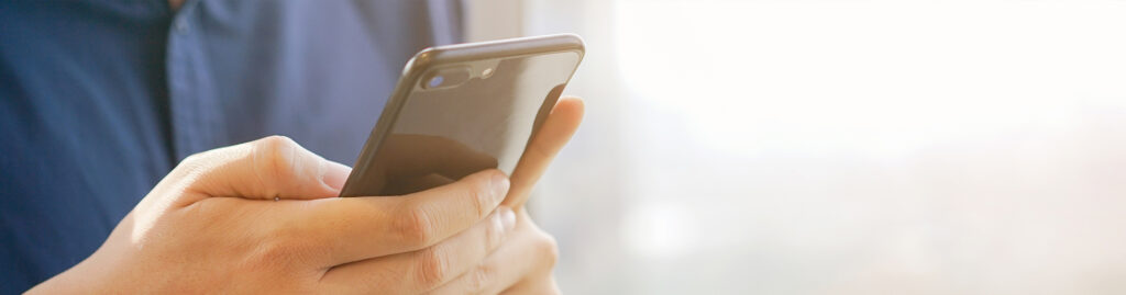 Hands holding a cell phone