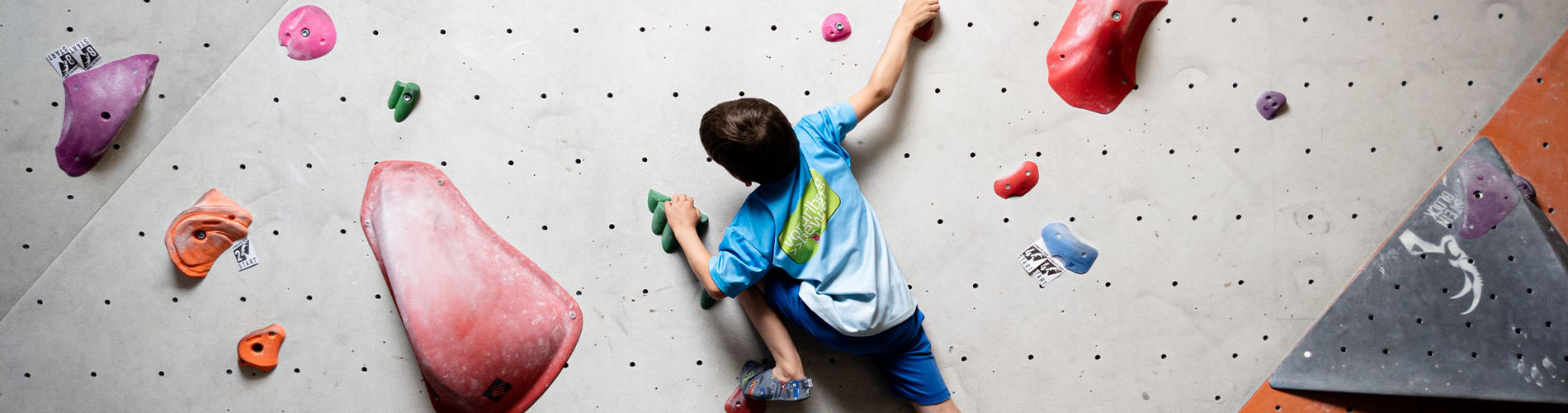 Boy rock climbing or bouldering