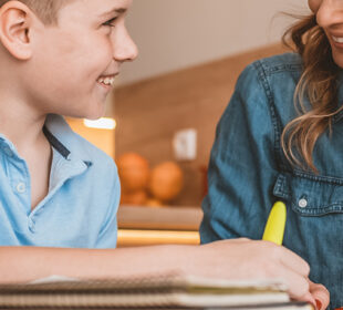 teacher helping boy with homework
