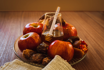 View of wooden table with symbols of Jewish New Year Rosh Hashanah.