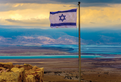 Israeli flag with a moody sky