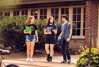 Three young adults in Hillel on Towson University's campus