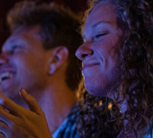 Young adults laughing at a comedy club