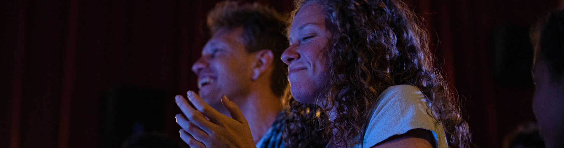 Young adults laughing at a comedy club