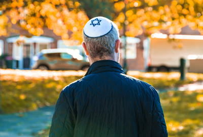 Jewish man walking on residential street