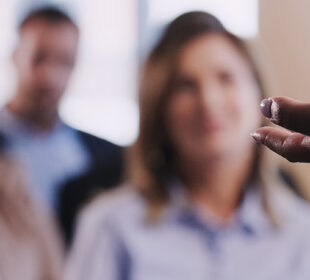 A man raises his hand at a lecture