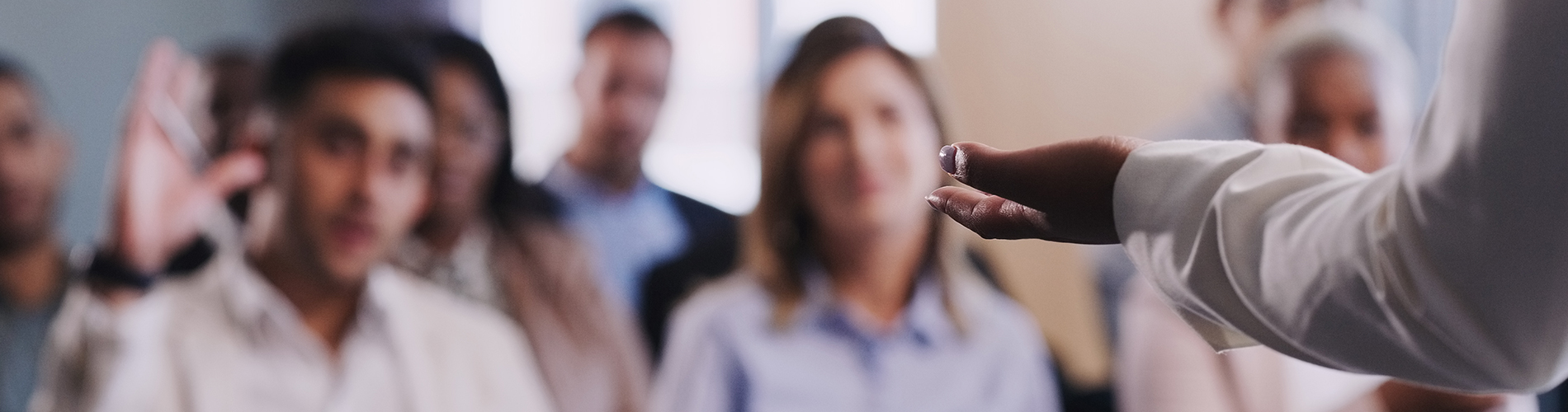 A man raises his hand at a lecture