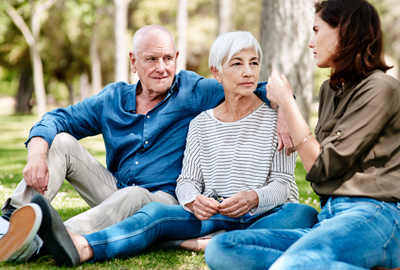 young woman spending the day outdoors with her elderly parents