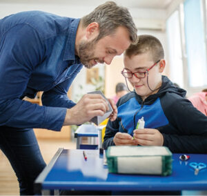 Teacher helping student