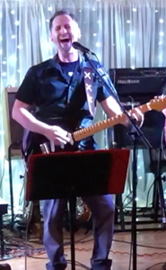 Brad Hecht playing a guitar