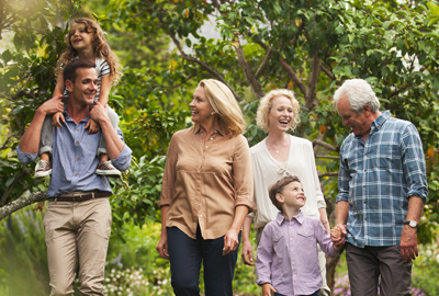 Multi-generation family walking together in park