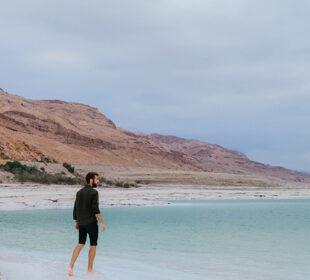 A man standing at the edge of the Dead Sea