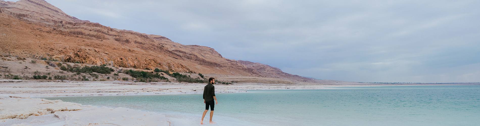 A man standing at the edge of the Dead Sea