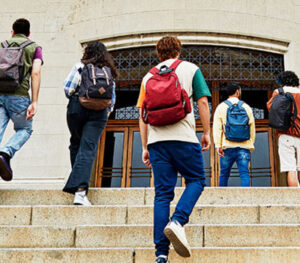 College students walking up building steps