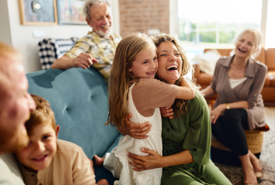Happy intergenerational family, mother hugging daughter