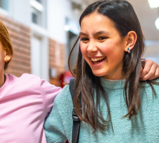 middle school students smiling at school