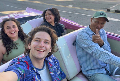 Esther Shapiro in the backseat of a pink car
