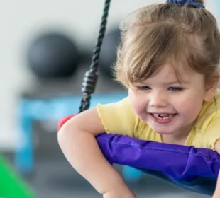 Child swinging at sensory gym