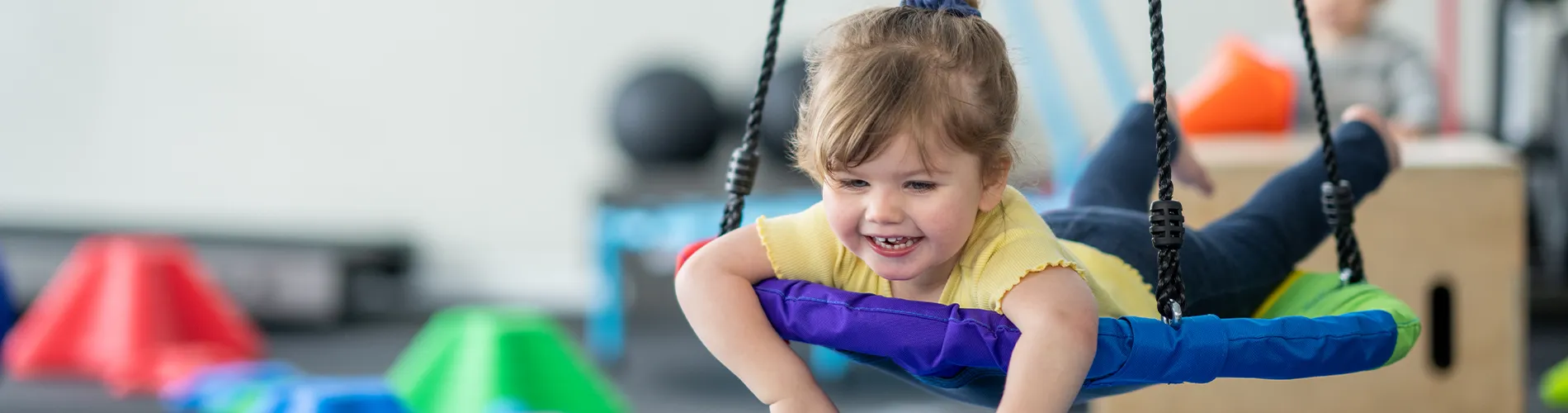 Child swinging at sensory gym