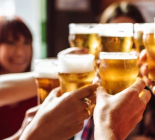 young adults cheers with beer
