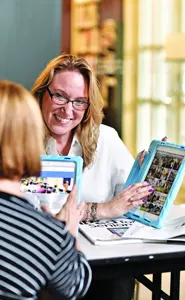 Melanie Waxman helping a senior with technology