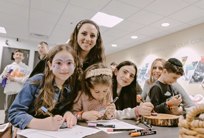 A family doing craft's at The Associated's 2026 Springfest