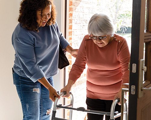 Woman assisting elderly woman